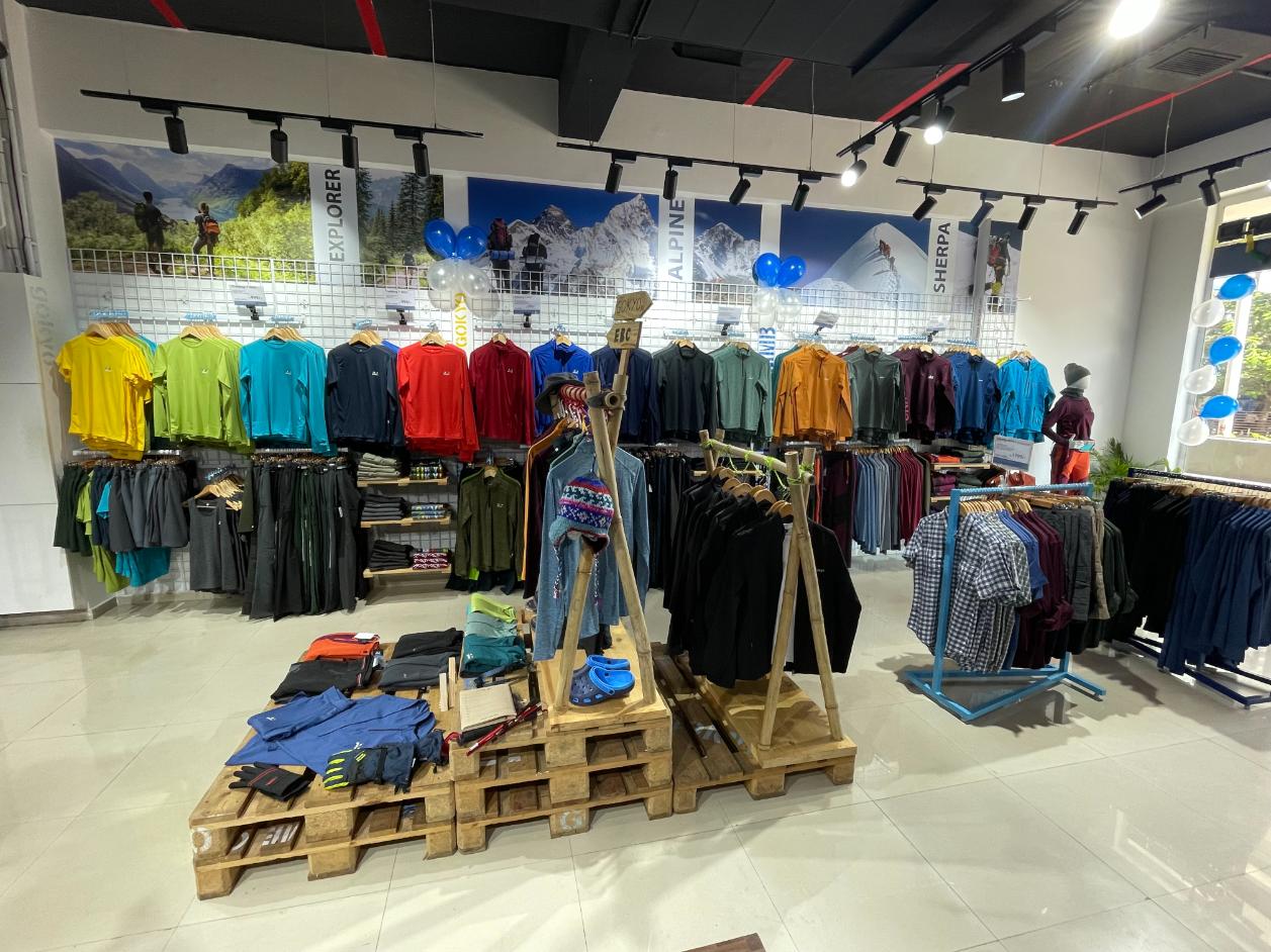 T-shirts, pants, jackets, and accessories arranged inside Gokyo Outdoor Clothing & Gear Malad store.